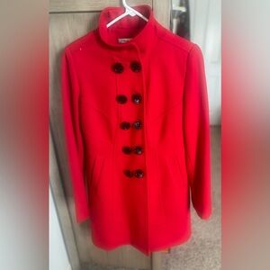 Warm, red stylish coat! Buttons in the front and on the sleeve of the coat.